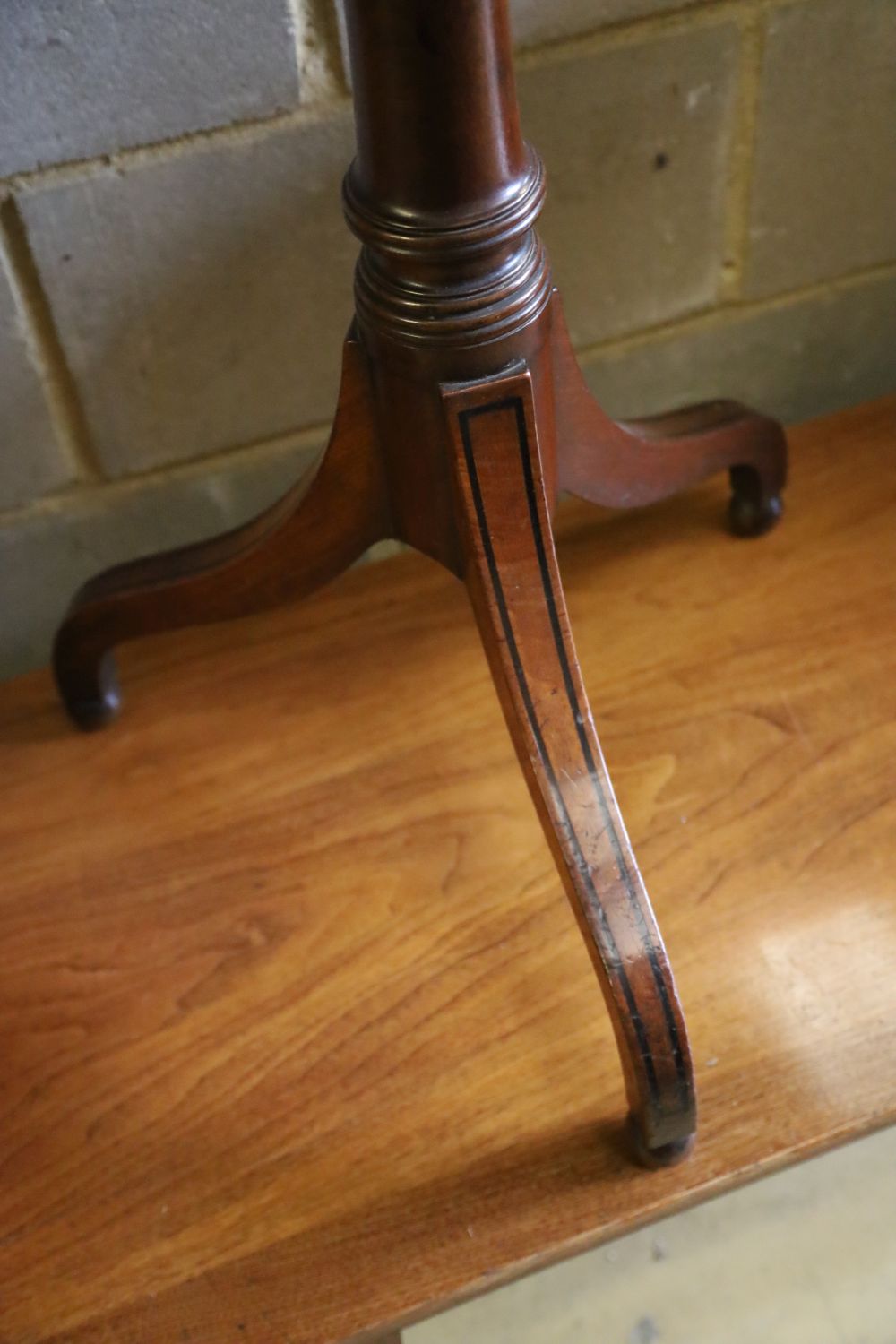 A mahogany tripod games table, width 61cm, depth 40cm, height 72cm